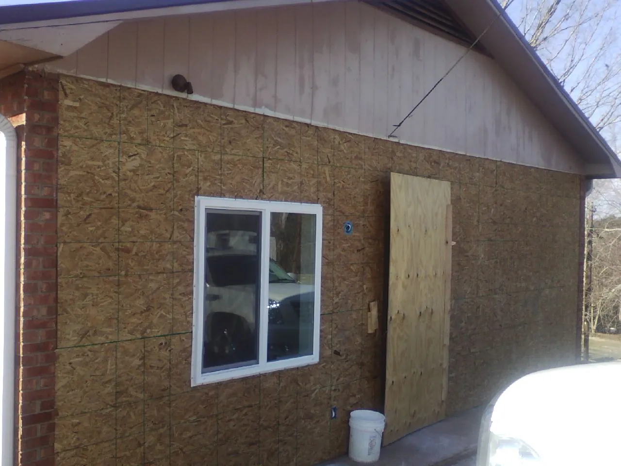 OSB sheathing on a garage addition wall before siding in Thompson Ridge